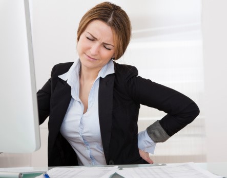 Professional office woman with back pain 