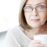 woman with menopause holding a cup of coffee